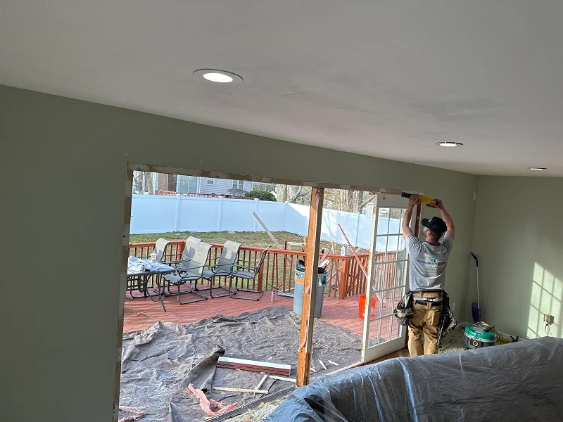 Window Solutions Plus master installer using a sawzall to remove the old patio doors